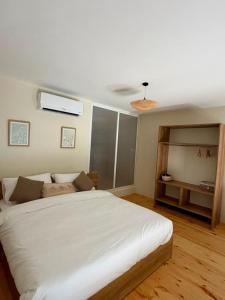 a bedroom with a large white bed in a room at CBreeze Guesthouse in Batroûn