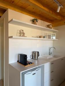 a kitchen with white cabinets and a counter with a sink at CBreeze Guesthouse in Batroûn +9 photos