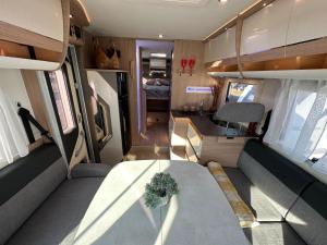 a table in an rv with a plant on it at Neptun Beach Caravans in Ulcinj