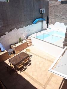a view of a swimming pool with a table and chairs at Villa de Ingenio JAVAZU in Ingenio