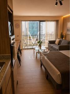 a living room with a bed and a couch at Deptos Estudios y de 2 dormitorios, Central, San Martin 2426. Sector Mall Plaza, Cowork y Factura. in Antofagasta