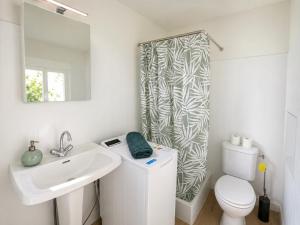 a bathroom with a sink and a toilet and a shower at Le Clos Castinet in Bollène