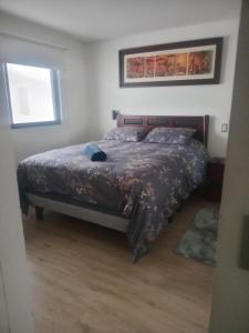 a bedroom with a bed and a window at El Colorado 21, Hasparren in El Colorado