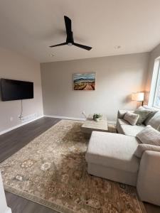 a living room with a couch and a ceiling fan at New Modern 2 Bedroom Apartment in Anchorage
