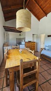 a dining room with a wooden table and chairs at DOS AGUAS in Capilla del Monte +10 photos