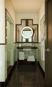 a bathroom with a sink and a mirror at The Warbler in New Orleans +4 photos