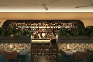 a restaurant with a bar with people sitting at tables at The Warbler in New Orleans