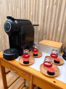 a coffee maker and some cupcakes on a table at Refúgio d’Aldeia da Serra in Seia