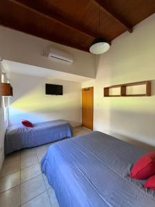 a bedroom with two beds and a flat screen tv at Complejo La Querencia de Colón in Colón +22 photos