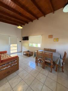 a dining room with a table and chairs in a room at Complejo La Querencia de Colón in Colón
