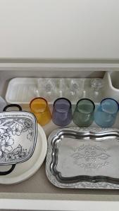 a drawer filled with different colored glasses and a plate at Yoonsul Gwangalli 3beds for 4guests in Suyŏng