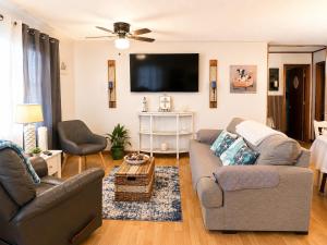 a living room with a couch and a flat screen tv at Waterfront Retreat in Slidell