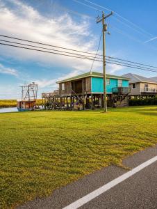 a building with a grass field in front of it at Waterfront Retreat in Slidell