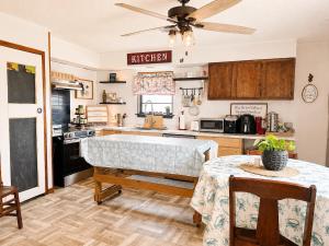 a kitchen with a table and a ceiling fan at Waterfront Retreat in Slidell