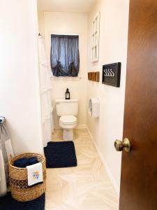 a bathroom with a toilet and a window at Waterfront Retreat in Slidell +27 photos