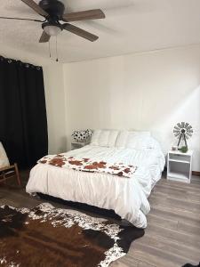 a bedroom with a bed and a ceiling fan at Waterfront Retreat in Slidell