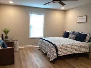a bedroom with a bed with blue pillows and a window at Pickwick Dreams in Counce