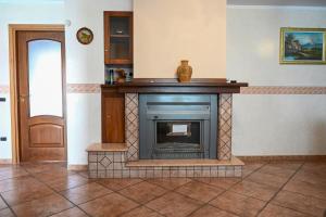 a fireplace in a room next to a door at Casa Experience - Acri in Calamia