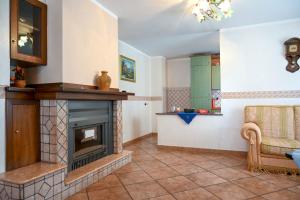 a living room with a fireplace and a couch at Casa Experience - Acri in Calamia +24 photos