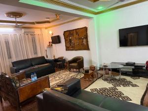 a living room with a couch and a table at Abbe Residence in Bamako