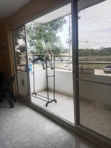 a room with a glass door with a view of a street at Apartamento centro oriente in Coveñas