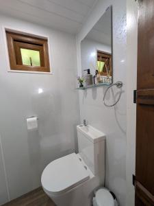 a white bathroom with a toilet and a window at The Willows in Scarisbrick +7 photos