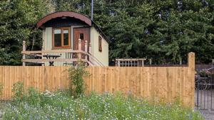 a small house behind a wooden fence at The Willows in Scarisbrick