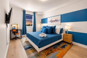 a blue bedroom with a bed with a stuffed animal on it at Coastal Retreat Near Hollywood Beach & Casinos in Hallandale Beach