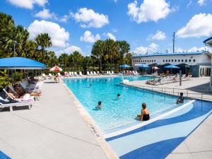 a pool at a resort with people in it at Coastal Retreat Near Hollywood Beach & Casinos in Hallandale Beach