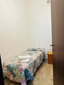 a bed with a quilt on it in a bedroom at A casa di Meggie in Dogliola +3 photos