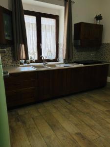 a kitchen with a sink and two windows at A casa di Meggie in Dogliola