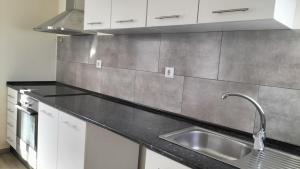a kitchen with a sink and a counter top at AL - Bino - T3 in Carregosa