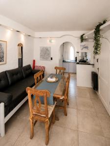 a living room with a table and a black couch at Despertá frente al mar! Loft con bajada privada! in Santa Clara del Mar