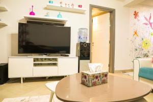 a living room with a tv and a table at Luxury Marassi Villa on Lagoon in El Alamein