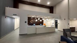 an office lobby with a reception desk and a kitchen at Comfort Inn & Suites in Penticton