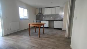 a kitchen with a table in the middle of a room at AL - Bino - T3 in Carregosa