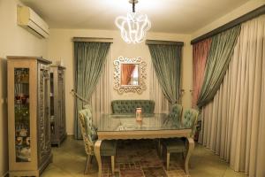 a dining room with a table and a chandelier at Luxury Marassi Villa on Lagoon in El Alamein