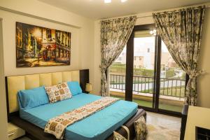 a bedroom with a bed and a large window at Luxury Marassi Villa on Lagoon in El Alamein +48 photos