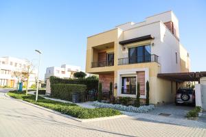 a building with a car parked in front of it at Luxury Marassi Villa on Lagoon in El Alamein
