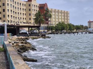 a body of water next to a city with buildings at MaFlo Arms in Belize City