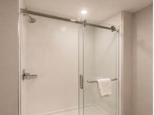 a bathroom with a shower with a glass door at Comfort Inn & Suites in Penticton +7 photos