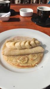 two pancakes on a white plate on a table at M E N T A R I hostel in Gili Gede +30 photos