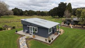 an aerial view of a tiny house in a field at Oak Lodge in Taheke