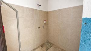 a shower with a glass door in a bathroom at El Árbol de la Vida in Bacalar