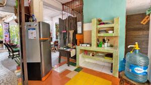 a kitchen with a refrigerator and a table at El Árbol de la Vida in Bacalar +93 photos