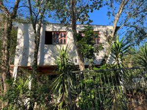 a house in the woods with a fence at Puerto Las marias in Candelaria