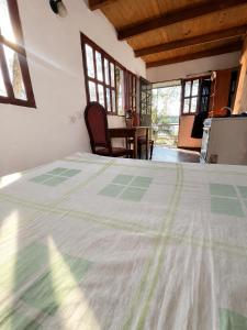 a bedroom with a bed and a table and windows at Puerto Las marias in Candelaria