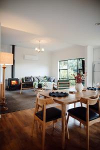 a living room with a table and a couch at Aurum Retreat in Reefton +82 photos