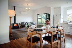 a kitchen and living room with a table and chairs at Aurum Retreat in Reefton