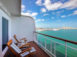 a balcony with chairs and a view of the ocean at Queen Elizabeth 2 Hotel in Dubai